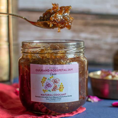 Spoonful of Culkand rose petal jam above an open jar of natural rose gulkand made with Damask rose petals and honey.